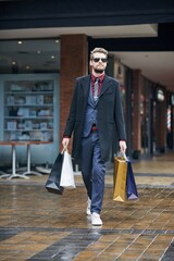 Man, shopping bags and formal clothes at mall, walking and customer or shopper, discount and...