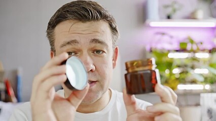 A middle-aged man tells and shows scented candle. Making candles for fragrance. the blogger is broadcasting live. 