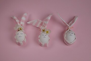 Easter eggs shaped as bunny against pink background. 