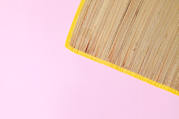 Straw mat on pink background. Straw mat concept. Pink background concept. Space for text.