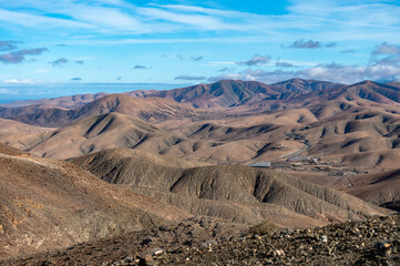 Panoramic view on colourful remote basal hills and mountains of Massif of Betancuria as seen from observation point, Fuerteventura, Canary islands, Spain
