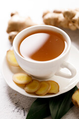 Ginger tea with ginger root and ginger slices.
