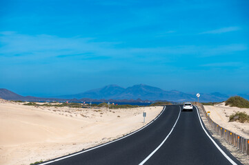 Driving car to north of Fuerteventura, sandy dunes, Corralejo, Canary islands, Spain