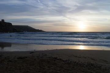 Stunning sunset over sea in Golden Bay Malta.