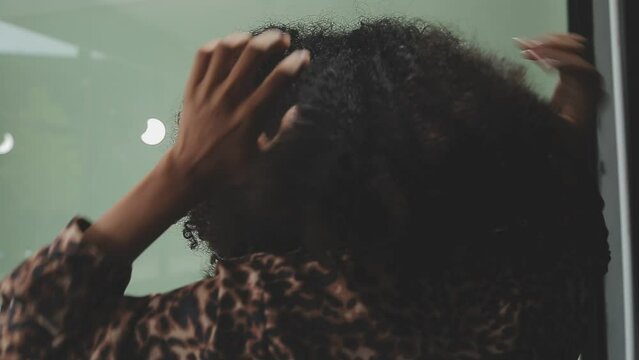 Close up of a woman twisting afro hair. Hair weaving