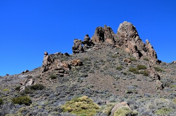 Scenic view of volcanic rock formations in desert during sunny day, Teide National Park, Tenerife