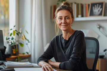 Relaxed mature woman posing at her home office desk, showing a blend of professionalism and comfort in a domestic setting