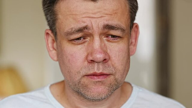 close-up. A middle-aged man is crying. men's pain and resentment. psychological support in crisis situations.