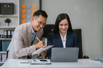 Fototapeta premium Asian business people working as a good team in the office. Successful teamwork in a meeting, workplace concept.