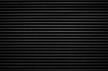 black tin iron corrugated wall with horizontal stripes from a metal profile of a metal sheet....
