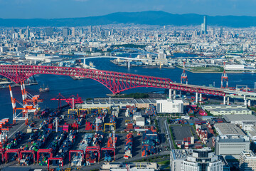 Osaka cityscape with Skyline and office building  and Logistic import and export containers and  crane bridge working at industrial delivery port warehouse for transport logistics oveasea