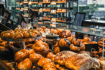 Delicious baked goods in the counter of a modern bakery and pastry shop, view from behind the counter