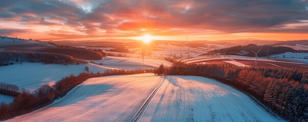 Aerial drone view of agricultural fields, wind turbines, and Matzen, Lower Austria at sunset during winter.