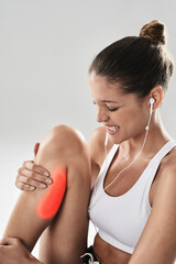 Fitness, woman and leg pain in studio with injury after running, practice or workout on gray background. Sport, exercise and person with red overlay for inflammation, calf strain or muscle tension © peopleimages.com