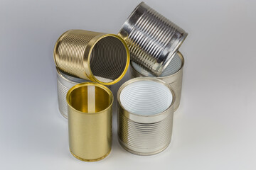 Open empty white and yellow tin cans different sizes