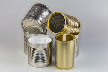 Open empty white and yellow tin cans different sizes