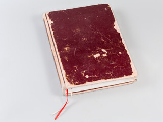 Old shabby book with marker reading ribbons on gray background