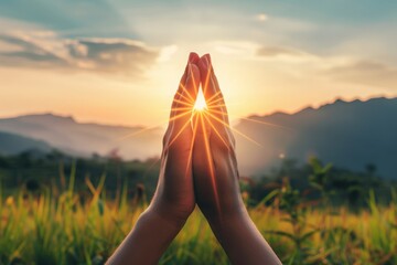 A person stands with outstretched arms, basking in the warm glow of the suns rays.
