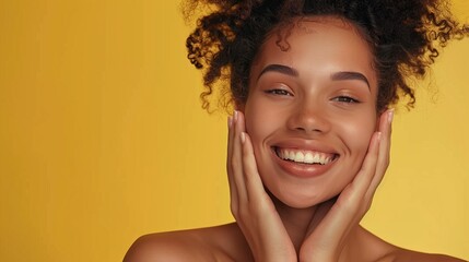 Beautiful woman touching her skin with joy cosmetic on a yellow background