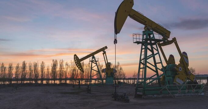 Time-lapse photography of oil well pumping unit from day to night