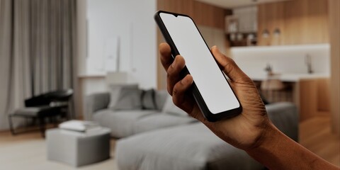 African-American Hand with smartphone in modern home, perfect for smart home app
