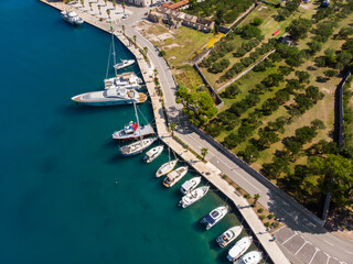 Scenic aerial view many yachts boats moored at Croatian bay harbor shore blue turquoise clear water...