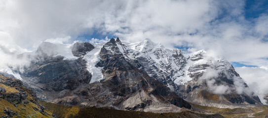 77MP Panoramic photo Mera peak 6476m with glacier lakes and snowy summits covered in white clouds....