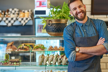 Portrait, businessman and happiness in cafe for startup company, restaurant and pride for work. Male person, small business owner and smile for nutrition and health in coffee shop in New York
