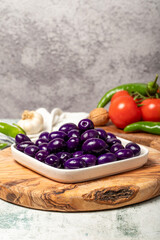 Purple or blueberry olives. Purple olives for breakfast in a plate