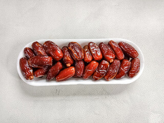 Dried dates in a plate. Kurma tunisia or sweet dried dates palm fruits. Dried dates.