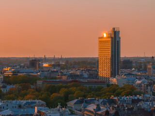 Aerial panoramic sunset over Riga old town in Latvia. Beautiful spring sunset over Riga. Golden hour fire sunset.