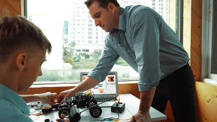 Teacher help student fixing car model and giving advise for programing system or coding prompt...