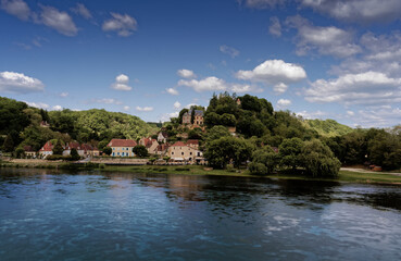 Fototapeta premium Village of Limeuil in the Dordogne, blue sky and river