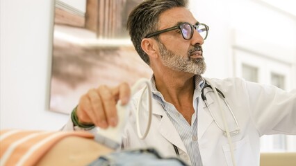 Doctor doing abdomen ultrasound examination of woman in clinic