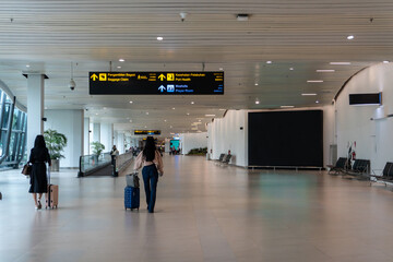 Passengers walking in travelator at airport
