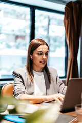 businesswoman in an office during a video call on her laptop