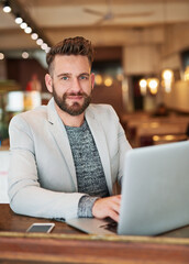 Businessman, portrait and laptop in coffee shop for email, conversation and communication with...