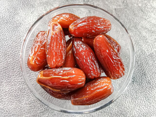 Dates fruit in a bowl. Sweet dried dates palm fruits. Dates fruit. Top view. 