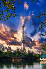 television TV tower in Tashkent in Uzbekistan with a reflection in the water of a river under a beautiful blue sky in spring at sunset