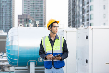 Male engineer worker checking, repair, maintenance operation sewer pipes area at construction site. Asian male engineer working in sewer pipes area at rooftop of building