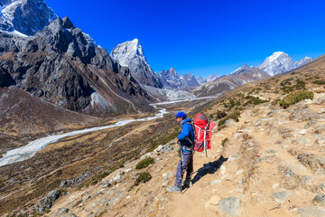 Sherpa mountain guide on his way from Dingboche to Dughla in the Khumbu region, Himalaya, Nepal