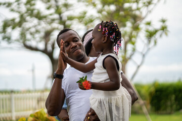 Portrait of enjoy happy love black family.play, having fun, daughter, parenthood, care, superhero.african american father and mother with little african girl child smiling moments good time at home