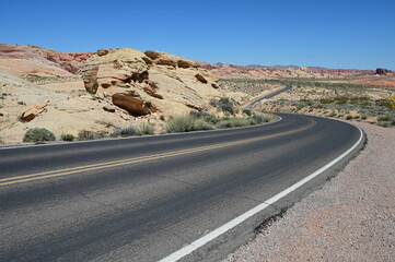 Road running through The Valley of Fire state park on a scorching April day in 2024.