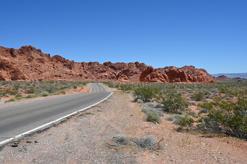 Road running through The Valley of Fire state park on a scorching April day in 2024.