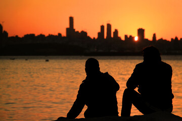 Two Men Silhouettes in Sunset