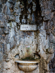 An artificial grotto made of thermal sinter stones with a drinking fountain built next to the Friedrichsbad in Baden Baden