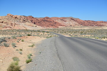 Road running through The Valley of Fire state park on a scorching April day in 2024.