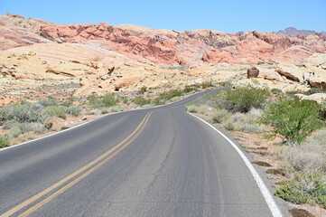 Road running through The Valley of Fire state park on a scorching April day in 2024.