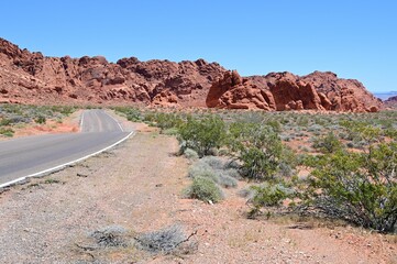 Road running through The Valley of Fire state park on a scorching April day in 2024.