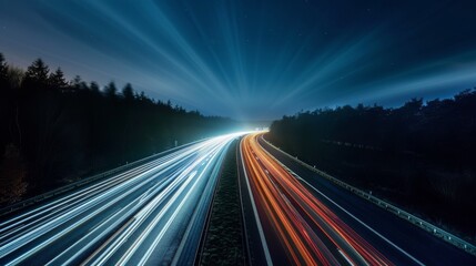 Obraz premium Nighttime long exposure of a road. A vibrant long exposure shot capturing the dynamic lights of cars traversing a road at night, reflecting the urban pulse